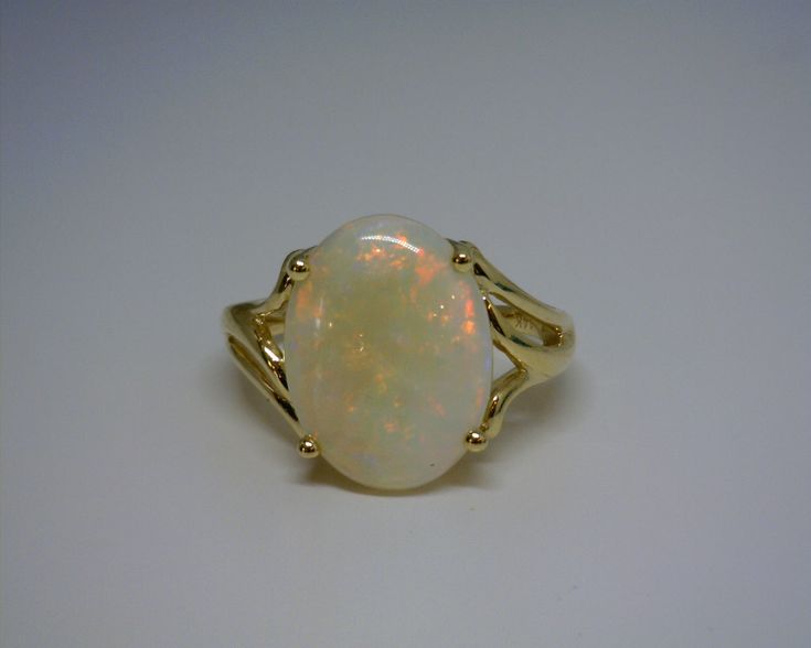 an opalite ring is shown on a white surface