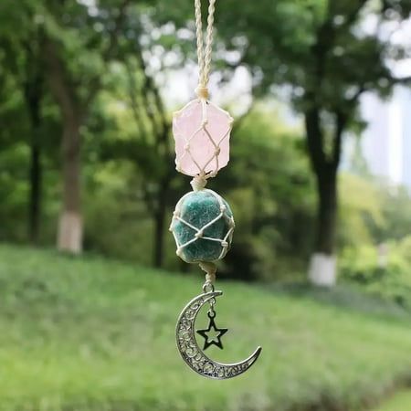 a wind chime hanging from a chain with a star and moon charm on it