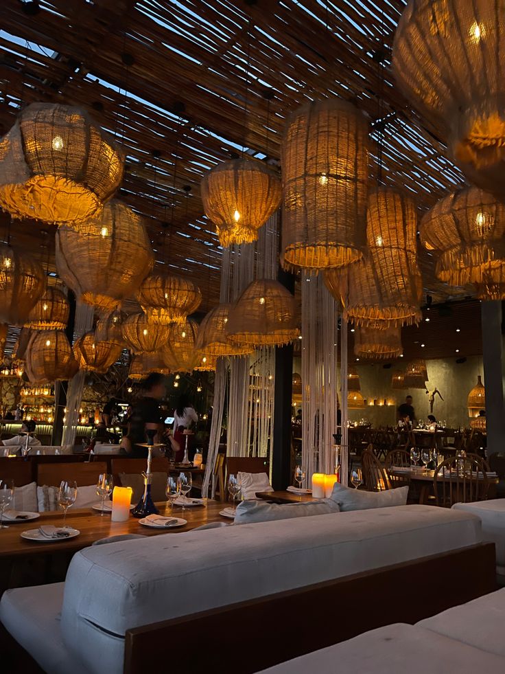 a restaurant with lots of lights hanging from the ceiling