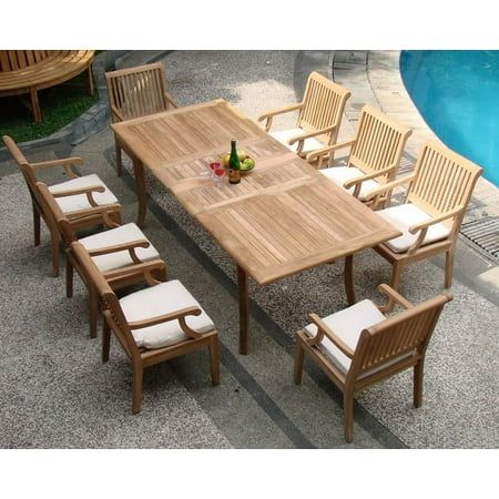 an outdoor table and chairs next to a swimming pool