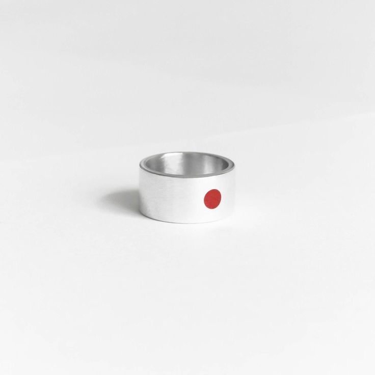 Symbol of sun - red circle on the white background. It's first association with Japan. Sun in Japan is symbol of honourable Imperator. We took leadership and strength from this meaning and put into this ring. Combination of red and white is combination of clearing energy of the sun and prime purity. On the other side of the ring is hieroglyph of the sun 太陽.  New autumn/winter collection! Gift for all who loves minimalism and simplicity of japan culture. Details:  Width: 10 mm Thickness: 1.2 mm Materials: sterling silver 925, enamel The surface has structure that does not cling or scratch. Please read my shipping and policies tab for shipping info.  All items are packaged in moisture resistant packaging to ensure they arrive in perfect condition. Don't hesitate to contact me with any questi Modern Red Open Ring, Red Minimalist Sterling Silver Ring, Minimalist Red Sterling Silver Ring, Minimalist Red Open Ring, Modern Red Ruby Ring, Modern Red Ruby Ring In Sterling Silver, Minimalist Red Ruby Ring, Minimalistic Ring, Japanese Sun