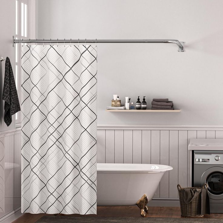 a bath room with a toilet and a bath tub next to a washer dryer