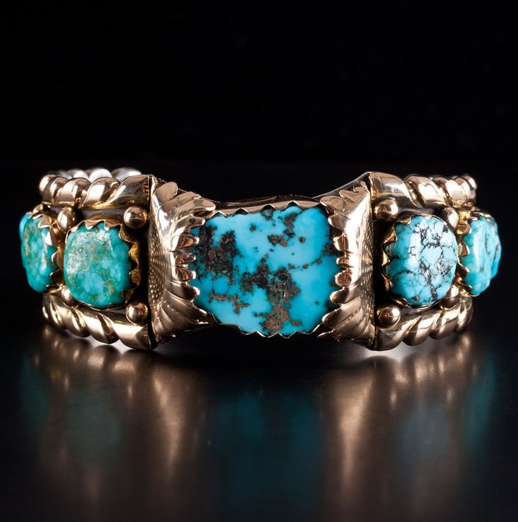 Vintage 14k Yellow Gold & Sterling Silver Zuni Morenci Turquoise Cuff Bracelet Metal Information: 14k Yellow Gold & Sterling Silver Total Weight: 86.2g Bracelet Width: 27mm Bracelet Length: 5.25" Bracelet Opening: 1.5" Circa: 1970's Center Stone: Morenci Side Stones: Sleeping Beauty Stone Information Main Stone Gem Type: Morenci Turquoise Shape: Cabochon (25 x 20mm) Color: Blue Clarity/Quality: A Number of Stones: 1 Accent Stones Gem Type: Sleeping Beauty Turquoise Shape: Oval (13.8 x 12mm) Colo Turquoise Bracelet Cuff 1stdibs, Artisan Turquoise Jewelry For Formal Occasions, Turquoise Bangle For Formal Occasions, Formal Turquoise Bangle Jewelry, Elegant Turquoise Bracelet With Patina, Elegant Turquoise Bracelets With Patina, Turquoise Bracelet Jewelry Collectible, Blue Multi-stone Bangle Jewelry, Blue Multi-stone Bangle