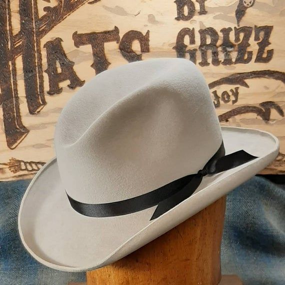 Please be sure to read all shop info and the FAQ's before measuring your head and placing an order as we are not able to offer returns or exchanges on our custom-built hats. Our legendary upgraded styles are built on discontinued, vintage Beaver Brand hat bodies which we recently purchased. The unfinished hat bodies had been in a storage shed for several years. Lil Grizz will re-block/reshape it by hand using traditional non-mechanized techniques into this particular style. These hat bodies had Custom Fitted Top Hat For Kentucky Derby, Fitted Wool Hats For Country Events, Fitted Felt Hat With High Crown For Country Events, Fitted Vintage Felt Hat For Western-themed Events, Vintage Fitted Felt Hat For Western-themed Events, Fitted Wool Felt Hat For Country Events, Fitted High Crown Fur Felt Fedora, Fitted Fur Felt Fedora With High Crown, Custom Fitted Brimmed Top Hat