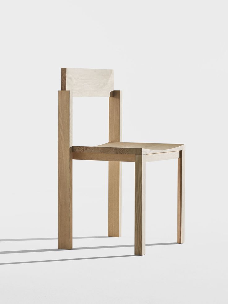 a wooden chair sitting on top of a white floor