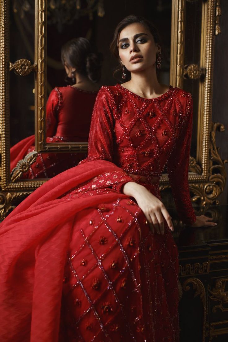 Red Lehenga Gown and Dupatta Pakistani Bridal Dress is an epitome of tradition and royalty and it simply wins everyone's hearts at the very first glance. Hand-crafted embellishments and premium fabric of this alluring Red Bridal Dress Pakistani make it your foremost priority. Gown: The hand-embellished Pakistani Gown in Brocade and mesh fabric is a stunning attire to pair with a Lehenga. The beautiful embroidery work and shimmering details on this stunning red gown make it an epitome of beauty. Traditional Floor-length Hand Embellished Salwar Kameez, Traditional Hand Embellished Floor-length Salwar Kameez, Hand Embellished Sharara For Traditional Ceremonies, Hand Embellished Traditional Sharara For Ceremonies, Bollywood Hand Embellished Dupatta For Traditional Ceremonies, Traditional Hand Embellished Gown For Eid, Traditional Hand Embellished Gown For Festivals, Traditional Hand Embellished Gown For Festive Season, Traditional Hand-embellished Gown For Festive Season