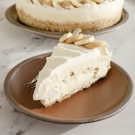 two pies sitting on plates with one slice missing