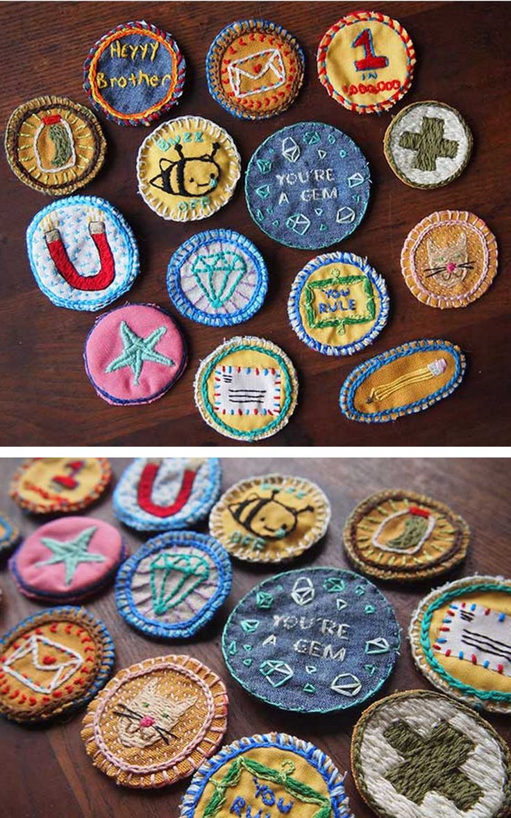 several different types of embroidered badges are on the table and in front of each other