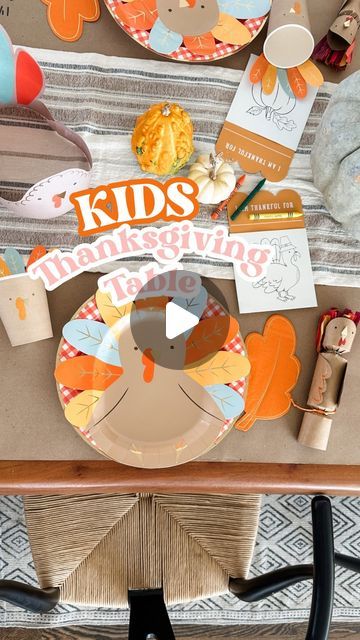 a wooden table topped with plates and paper turkeys