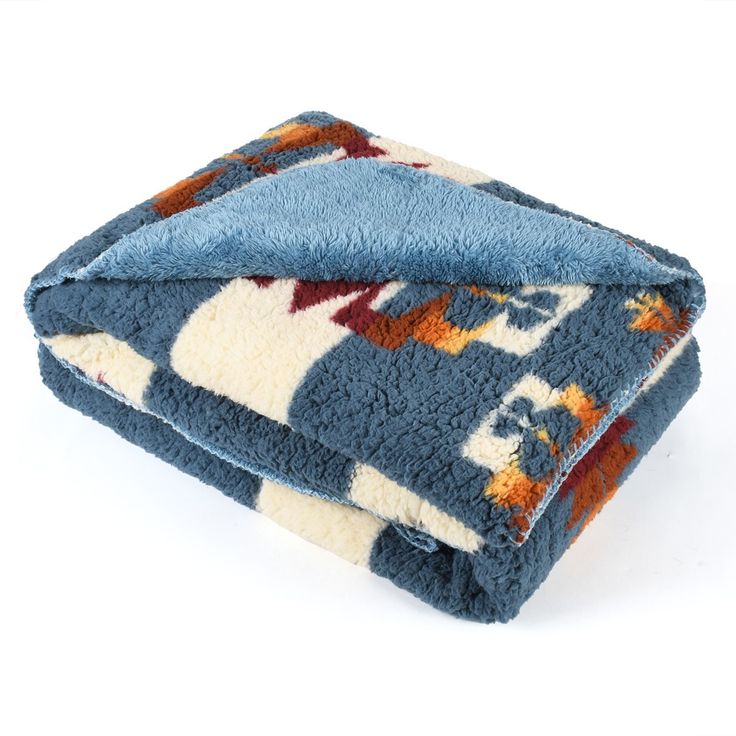 two towels folded on top of each other in blue and orange colors with an elephant design