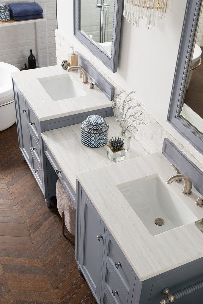 a bathroom with two sinks and a large mirror above the sink is decorated in blue and white