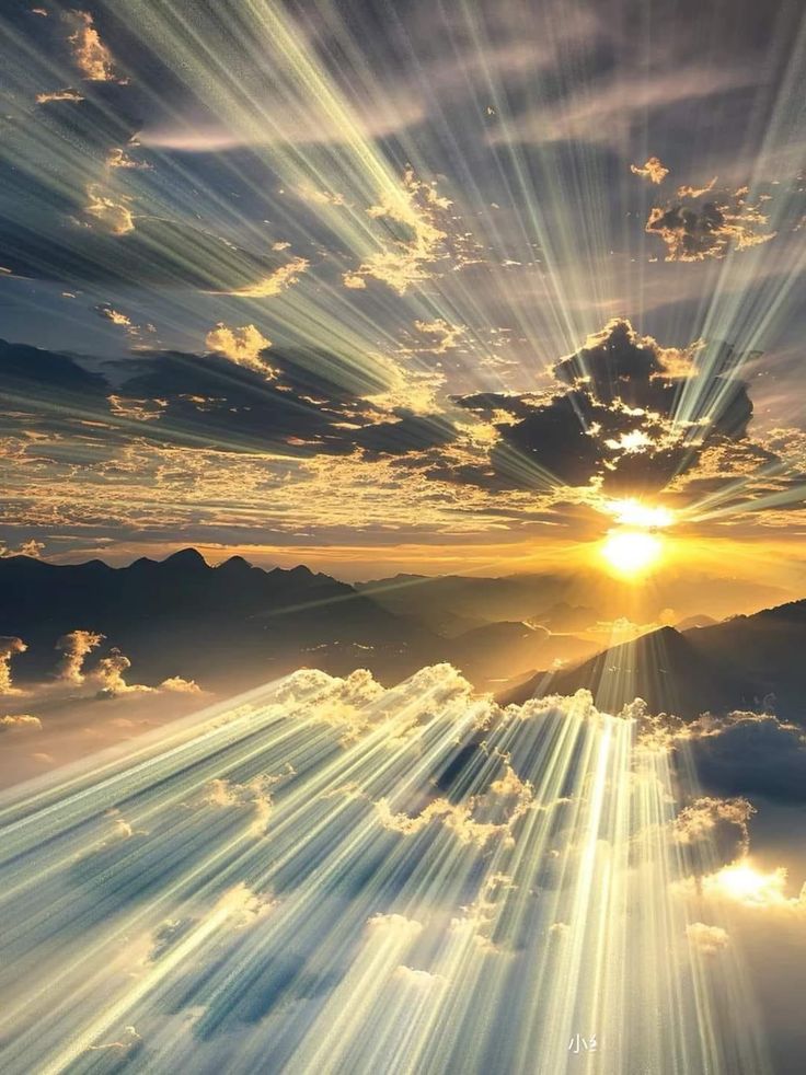 the sun shines brightly through clouds in this artistic photo taken on top of a mountain