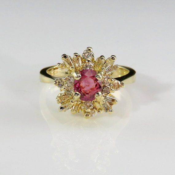 A beautiful precious earth mined pink sapphire and fine white diamond engagement ring dating to the mid century era crafted in 14K yellow gold. This classic ring designed as a ballerina style cluster setting is of heirloom quality. The beautiful pink sapphire itself has a unique pink color with just a hint of violet. The color is soft and feminine but definitely not ice cream it's more like the most exquisite dusty rose you could imagine. It weighs 5 grams. Currently it is a size 6 to 6 1/8 US. Sapphire Ring Designs, Sapphire Anniversary Ring, Engagement Ring Pink, Pink Sapphire Diamond Ring, Pink Sapphire Engagement Ring, Ballerina Ring, Pink Engagement, Sapphire Anniversary, Vintage Gold Engagement Rings