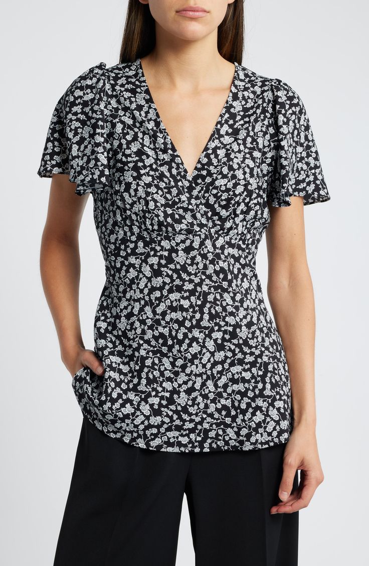 Flutter sleeves and perfectly placed gathers bring sweet energy to this flowy top. 25 1/2" length (size Medium) V-neck Short sleeves 100% rayon Hand wash, dry flat Imported Flowy V-neck Blouse With Floral Print, Feminine Flowy V-neck Top, Elegant Floral Print V-neck Top, Casual V-neck Top With Gathered Neckline, Elegant V-neck Floral Print Tops, Summer Flutter Sleeve Top With Gathered Sleeves, Floral Print Flutter Sleeve Tops For Brunch, Flutter Sleeve Floral Print Top For Brunch, Summer Flowy Top With Gathered Sleeves