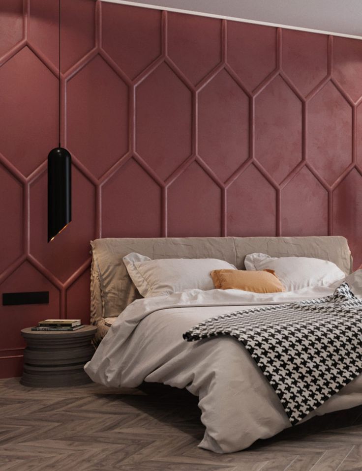 a large bed sitting in a bedroom next to a wall with geometric designs on it