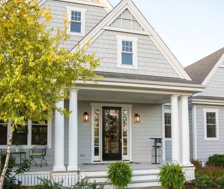 a gray house with white trim and windows