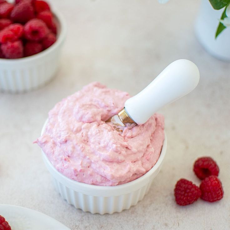 raspberry dip in a white bowl with fresh raspberries