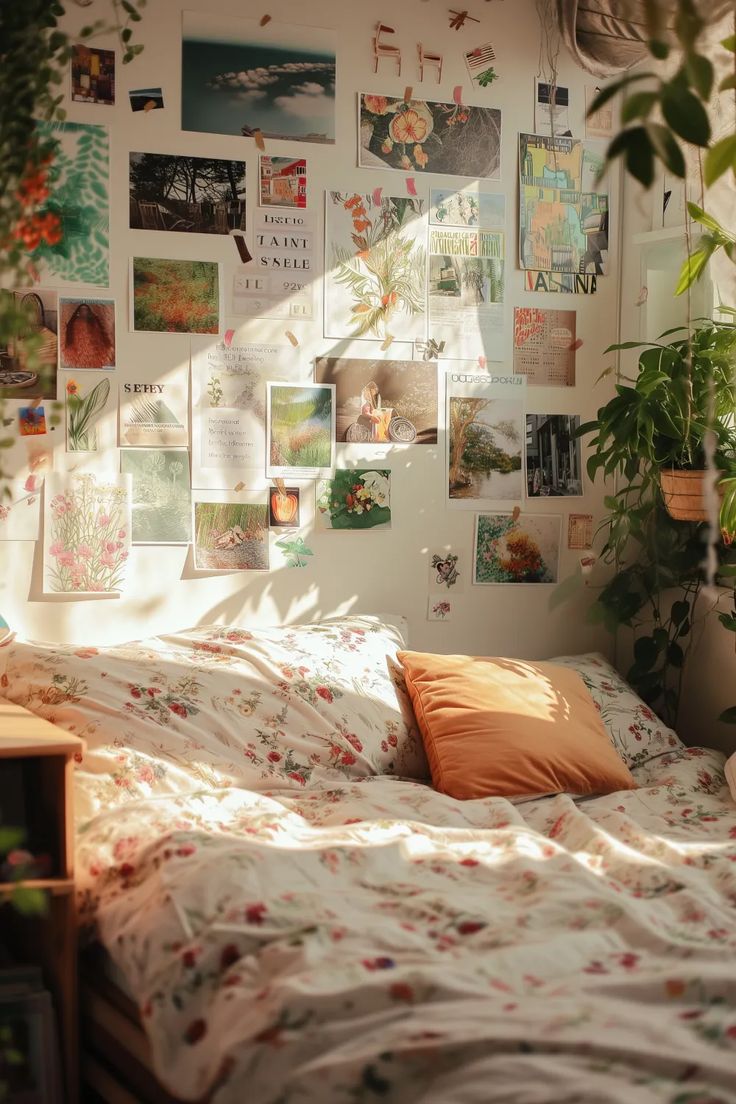 an unmade bed with lots of pictures on the wall above it and plants in pots