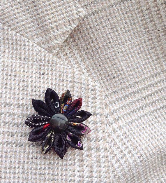 A black lapel flower pin boutonniere made in the Japanese tsumami kanzashi style, for men and women! This attention-grabbing pin is a unique fashion accessory no one else can own. I used 10 different mostly black silk fabrics for the flower, affixed a teardrop obsidian coin bead into Elegant Black Lapel Pin For Formal Occasions, Black Brooch Lapel Pin As Gift, Black Lapel Pin Brooch As Gift, Black Lapel Pin Brooch For Gift, Elegant Black Lapel Pin For Wedding, Elegant Black Business Lapel Pin, Black Formal Brooch Lapel Pin, Elegant Flower Lapel Pin For Gift, Black Brooches With Handmade Flowers For Gift