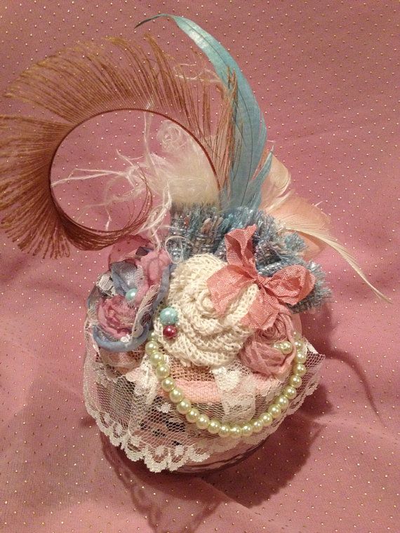 For a truly vintage-style and classy touch to your photos, one of these fabulous fascinator hats is a must have! This design features an ivory lace, vintage aqua blue, and dusty rose colored singed satin flower with a pearl beaded center, a boucle aqua fabric ruffle, an ivory Vintage Cream Mini Hat For Formal Events, Vintage Cream Mini Hat For Formal Occasions, Vintage Evening Fascinator With Feathers, Vintage Mini Hats With Feathers For Party, Elegant Mini Hats With Feathers For Gifts, Elegant Mini Hats With Feathers As Gifts, Elegant Mini Hat With Feathers For Gift, Elegant Mini Hat With Feathers As Gift, Handmade Vintage Hat Fascinator