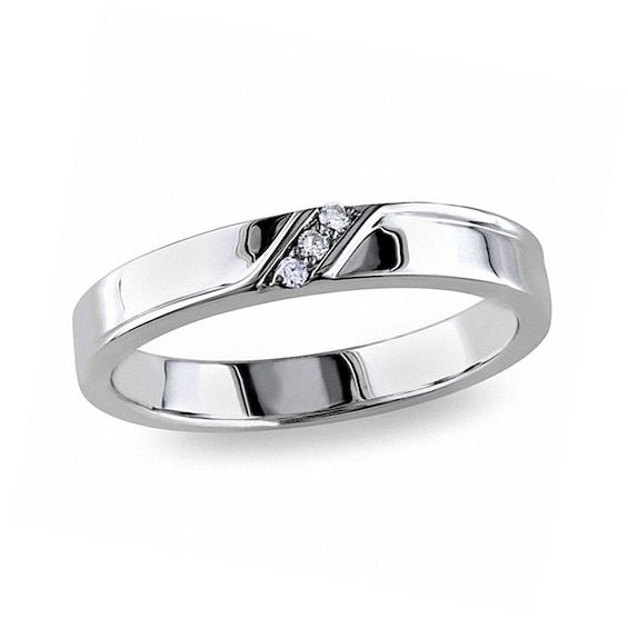 Simple and sleek, this handsome wedding band boasts a subtle hint of shimmer. Created in sterling silver, this band features a trio of diamond accents set on the diagonal across the center. Squared edges add dimension to this stylish design. A meaningful symbol of your loving commitment, this wedding band is finished with a bright polished shine. Custom made to fit his ring size. Sterling silver rings cannot be resized after purchase. Minimalist Channel Set Rings For Formal Occasions, Modern Formal Stackable Channel Set Rings, Formal Minimalist Channel Set Ring, Modern Channel Set Stackable Rings, Modern Silver Bands With Round Cut, Modern Diamond White Stackable Rings For Formal Occasions, Modern Brilliant Cut Bands For Anniversary, Modern Single Diamond Stackable Rings For Formal Events, Modern Stackable Rings In Diamond White For Formal Occasions