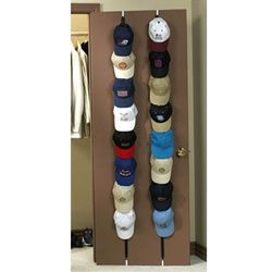 several hats hanging from hooks in a closet