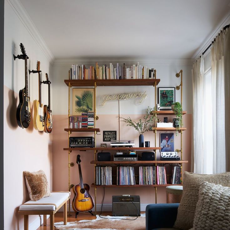 a living room filled with lots of furniture and bookshelves covered in musical instruments