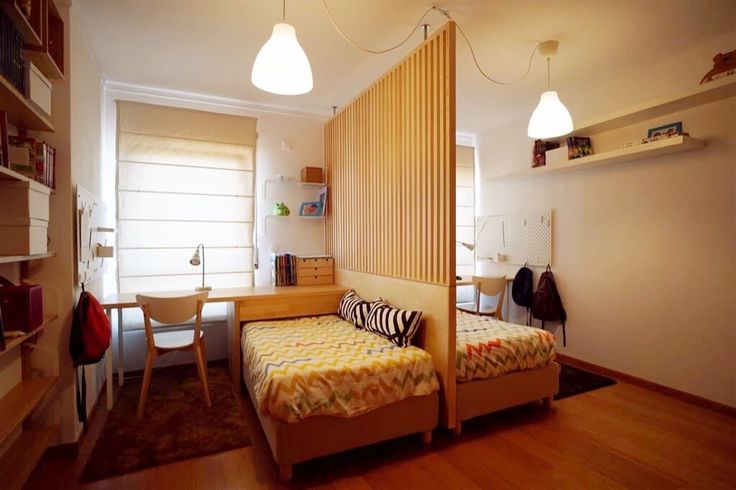 a bed room with a neatly made bed next to a desk and shelves on the wall