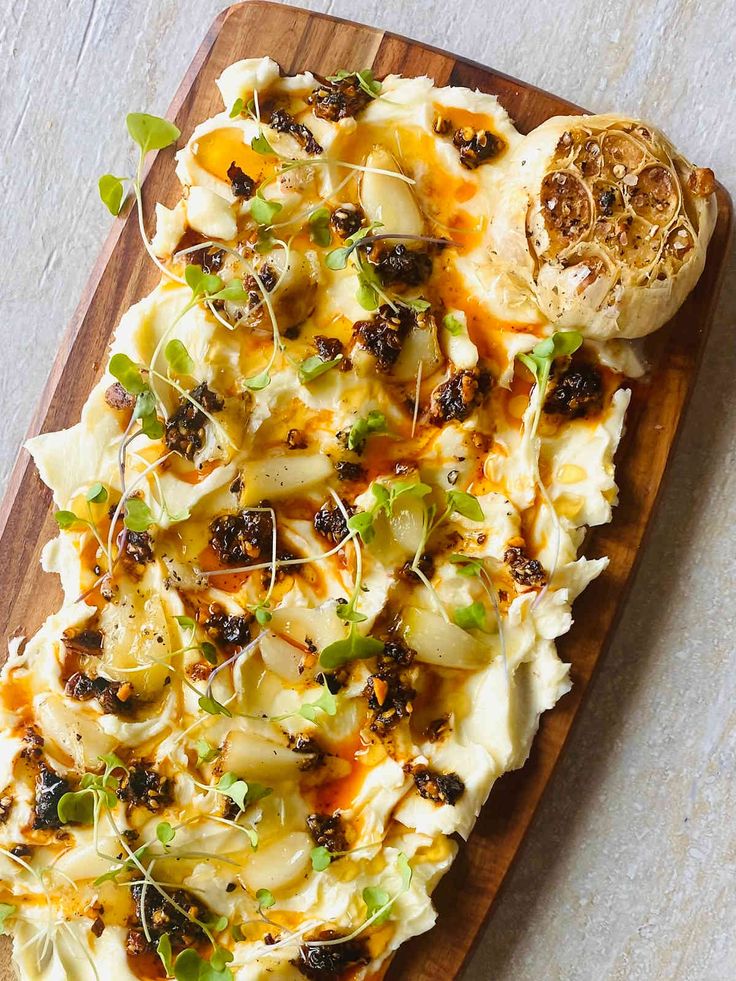 a wooden platter filled with food on top of a table