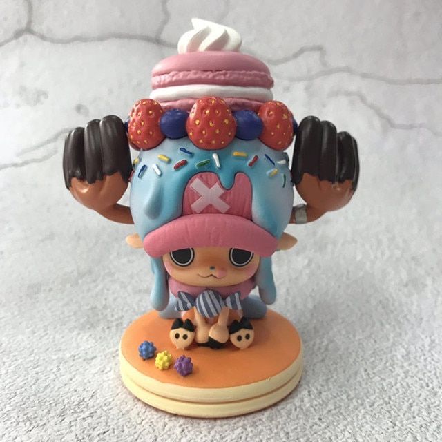 a toy figurine is sitting on top of a white surface and it looks like she's wearing a pink hat