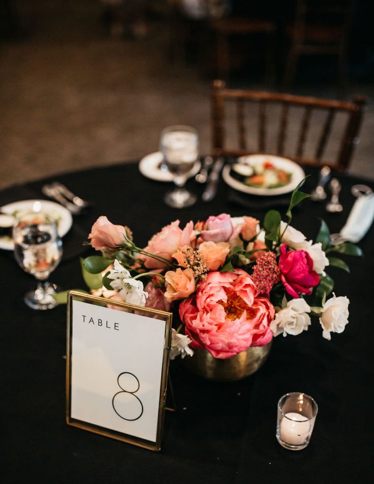 a table with flowers and place cards on it