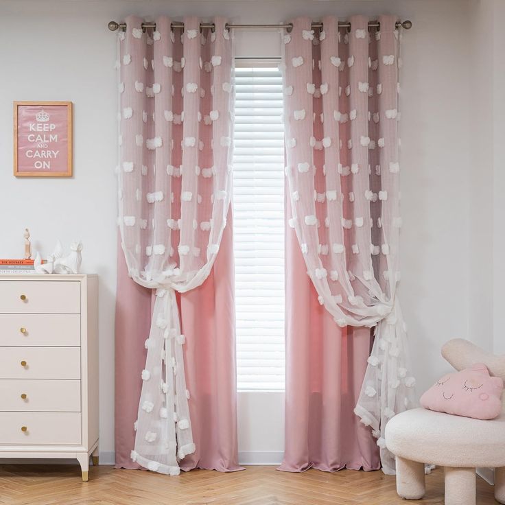 a baby's room with pink curtains and white furniture