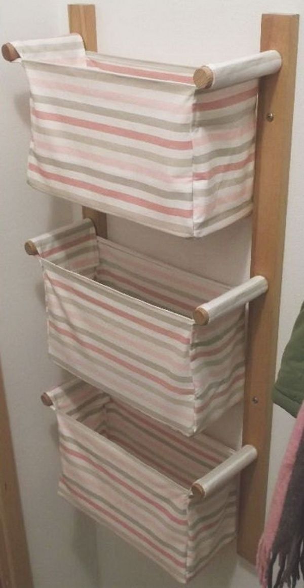 a shelf with several folded towels on it and a towel rack in the corner next to it