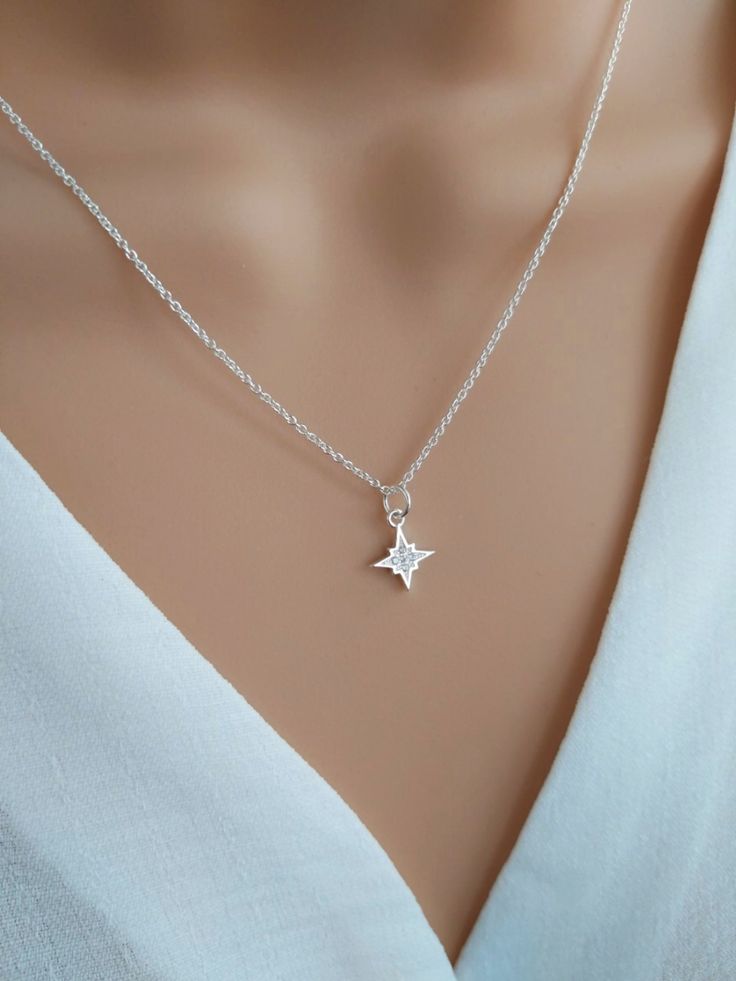 North star necklace sterling silver, Polaris starburst necklace, celestial star jewelry, silver cz diamond star necklace Shine bright with our gorgeous North Star necklace!  Handcrafted with care using a tiny sterling silver & cubic zirconia North Star charm and delicate sterling silver chain, this dainty necklace symbolises hope and inspiration.  The North Star is the anchor of the northern sky, giving guidance and direction to those who follow it. Stunning little cubic zirconia crystals mimic Celestial Star-shaped Sterling Silver Jewelry, Dazzling Star-shaped White Gold Necklace, Dazzling Star Shaped White Gold Necklace, Dazzling White Gold Star Necklace, Celestial Star-shaped Silver Jewelry, Dainty Cubic Zirconia Jewelry With Star Charm, Silver Star-shaped Dainty Jewelry, Silver Star-shaped Diamond Necklace, Star-shaped Diamond White Necklace For Anniversary