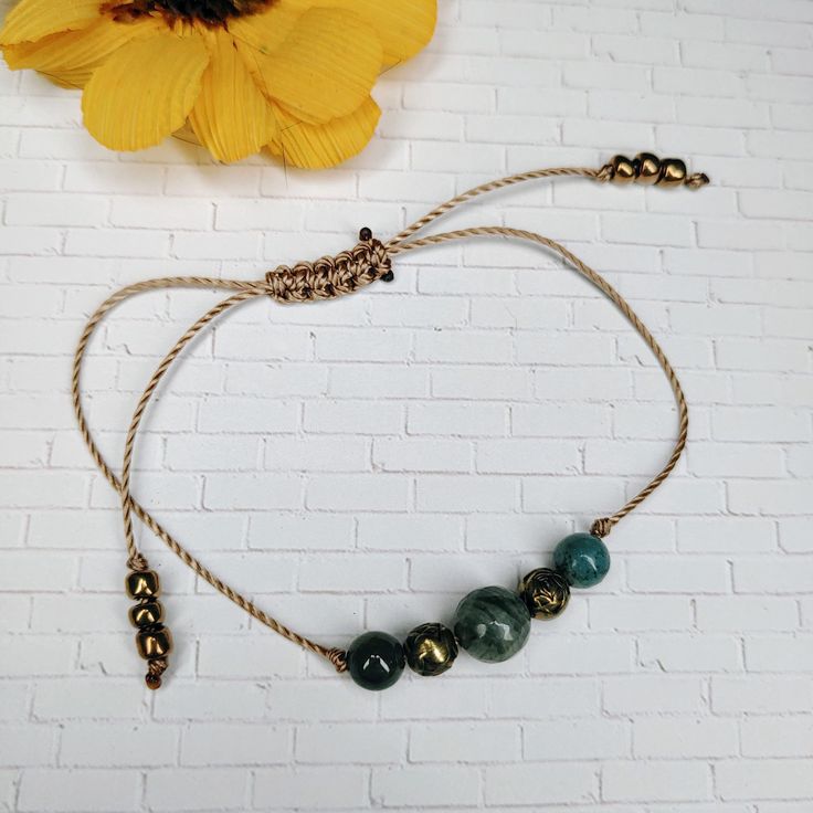 This Green Jasper adjustable bracelet is made with high quality S-Lon cord in a medium brown color. The center bead is an 8mm round Jasper.   The other beads are round metal flowers and 6mm round Jasper beads.   It opens up to 9" to slip over the largest part of your hand and then you pull the ends together to fit around your wrist. ✶ QUICK SHIPPING! ✶ I make every effort to get your order processed and shipped as soon as possible. Order processing takes 1-2 days, and I typically ship the orders the same day they are processed. Orders placed on the weekend (Sat/Sun) may take an additional 1-2 days to process and ship. ✶ RETURNS: While I don't accept returns, your 100% satisfaction is my priority. Please message me with any issues concerning your order and I will do what I can to make it ri Nylon Cord Bracelet, Medium Brown Color, Jasper Bead Bracelet, Jewelry Nature, Green Jasper, Yoga Jewelry, Boho Bracelet, Bracelet Boho, Cord Bracelet