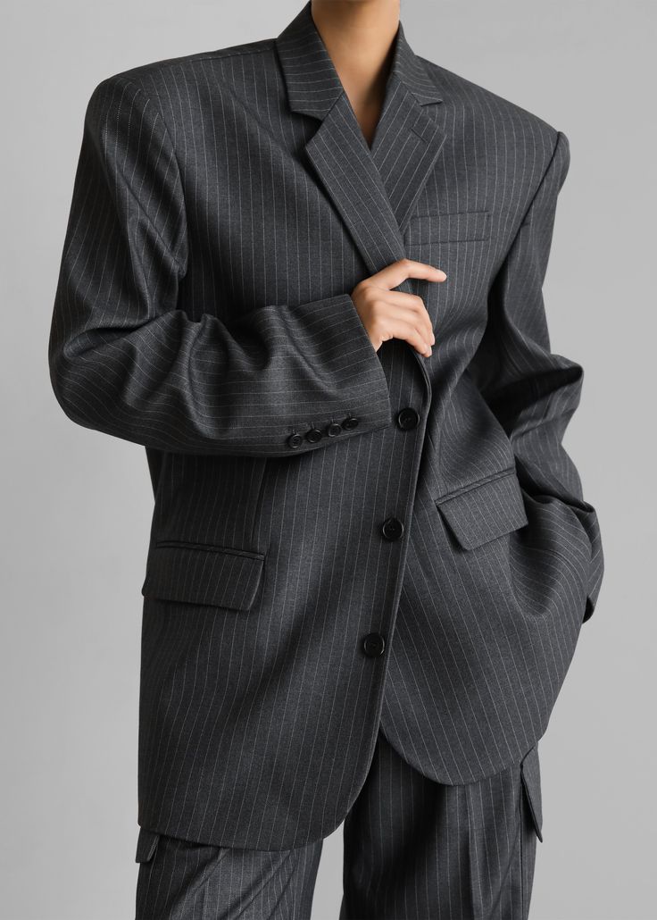 Color: Grey/White Pinstripe Midweight traditional suiting fabric Oversized fit Notch lapels Padded shoulders Button cuffs Single welt breast pocket Front illusion flap pockets Front button closure Lined 75% Polyester 25% Rayon Dry Clean By The Frankie Shop. Imported