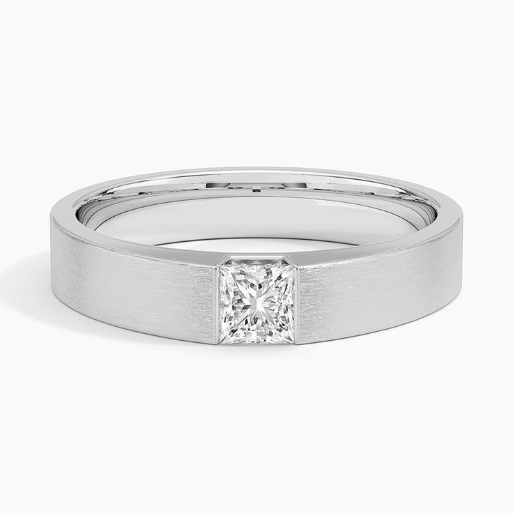 a white gold ring with a princess cut diamond in the center and a thin band