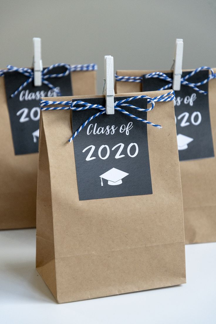 three brown paper bags tied with twine and graduation tags that say class of 2020