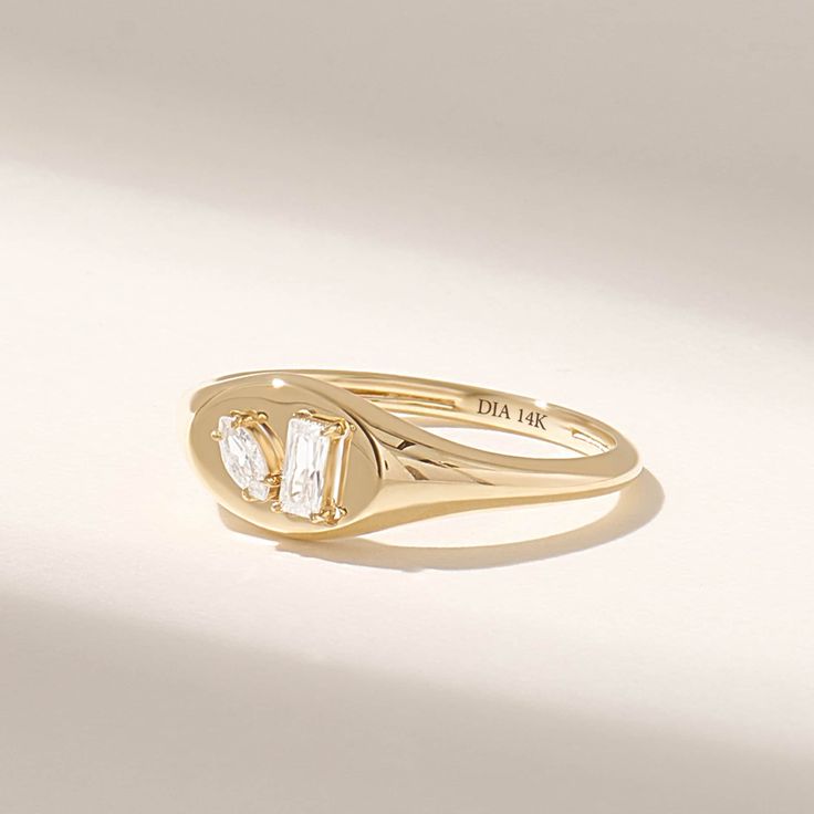 The Baguette and Marquise Diamond Dome Signet Ring is a striking and unique piece of jewelry that blends classic elegance with modern design. Crafted from 14k solid gold, this ring showcases the diamond at its center, adding a touch of luxury and sophistication to your style. Features * Made to Order. * Gold KT: 10K, 14K, 18K * Width of Band: 1.70MM * Width of Top: 7.00MM * Thickness of Band: 1.45MM * Custom Gold Color: Rose Gold, Yellow Gold, White Gold * Diamond Color- Clarity: D-E-F color VVS clarity (excellent ideal cut) Baguette and Marquise Cut *Total Ctw: 0.23 ctw * Ready to Ship in 5-7 Business Days ✓ We care about the environment,the jewelry we cast is made with recycled gold. We source exclusively post-consumer material that is refined back to their pure elements to ensure that t Bezel Signet Ring, Signet Diamond Ring, Oval Diamond Ring With Baguette Diamonds, Oval 14k Gold Rings With Baguette Diamonds, Oval Rings With Baguette Diamonds In 14k Gold, Corporate Woman, Diamond Pinky Ring, Pinkie Ring, Oval Signet Ring