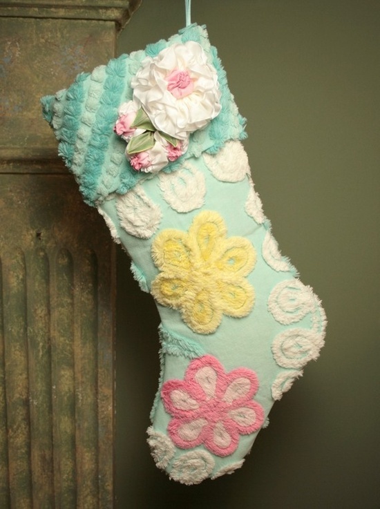 a christmas stocking hanging from the side of a wooden pole with flowers on it