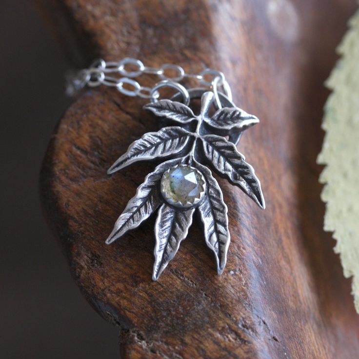 "Hand sculpted fine silver ash leaf pendant with faceted labradorite stone. A botanical talisman symbolic of reverence for nature ~ complete with its very own little halo. A wearable idol for every day!  Celtic mythology considers it a deeply sacred tree to which many supernatural powers are attributed. Scandinavian legend presents this tree as the original support of the world, associating it with the myth of creation since it gives rise to both the upper and lower worlds. It is symbol of transformation and strength. This pendant represents a substantial amount of solid fine silver (.999 / 99.9% pure silver) and has a lovely weight and feel. The original design is detailed and intricate both front and back and while appropriate for everyday, would also be a treasured member of any heirloo Silver Labradorite Necklace Nature-inspired, Silver Labradorite Necklace, Nature-inspired, Silver Labradorite Necklace With Nature-inspired Style, Nature-inspired Silver Labradorite Necklace, Silver Labradorite Nature-inspired Jewelry, Nature-inspired Silver Labradorite Jewelry, Leaf Necklace Silver, Ash Leaf, Yggdrasil Tree