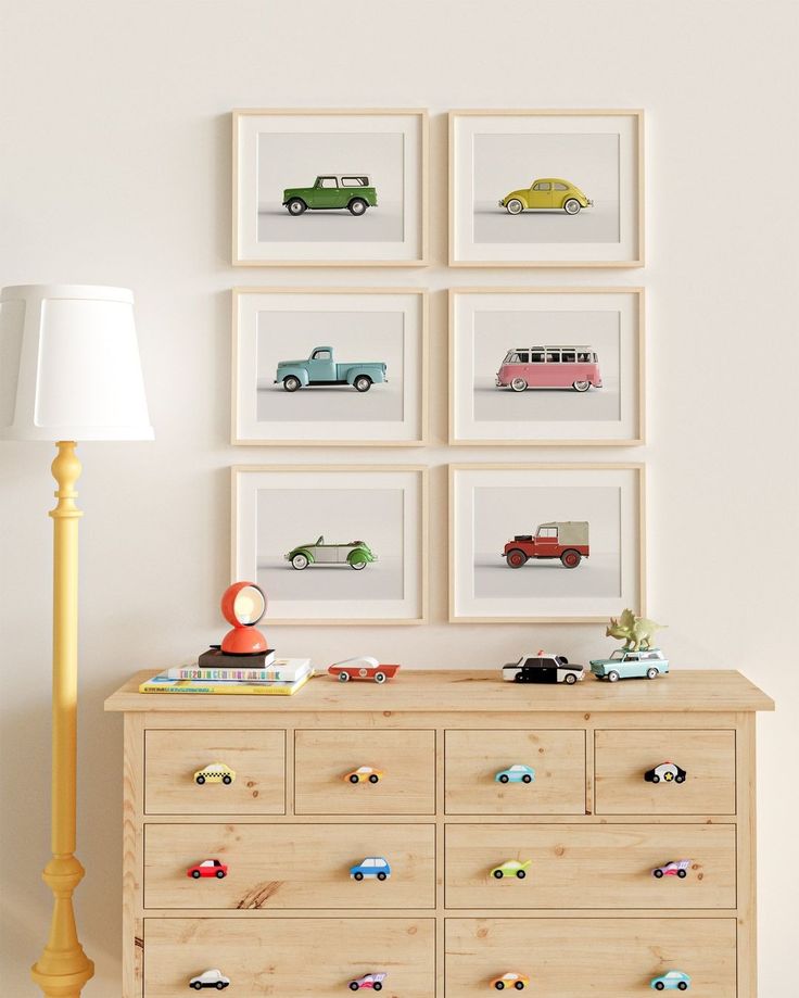 there is a dresser with many cars on it and a lamp next to the dresser