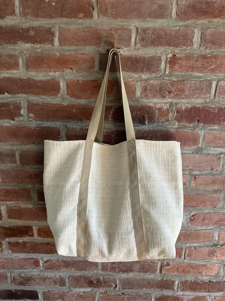 Reusable Handcrafted Tote Bag made from repurposed, sturdy upholstery material.  Solid Beige Pattern 12"H x 20"W, with a 6" gusset (base) Material: Heavy Upholstery Weight Material 1" taupe webbing handles, reinforced for strength  Each bag is unique and handmade to spruce up your shopping experience and decrease your dependence on plastics. Eco-friendly Upcycled Bags For Daily Use, Everyday Woven Canvas Bag, Large Natural Canvas Bag For Everyday Use, Everyday Upcycled Beige Bag, Eco-friendly Cream Canvas Bag For Everyday Use, Eco-friendly Beige Shoulder Bag For Errands, Eco-friendly Upcycled Canvas Bag, Eco-friendly Upcycled Bags From Recycled Materials, Natural Reusable Canvas Bag For Daily Use