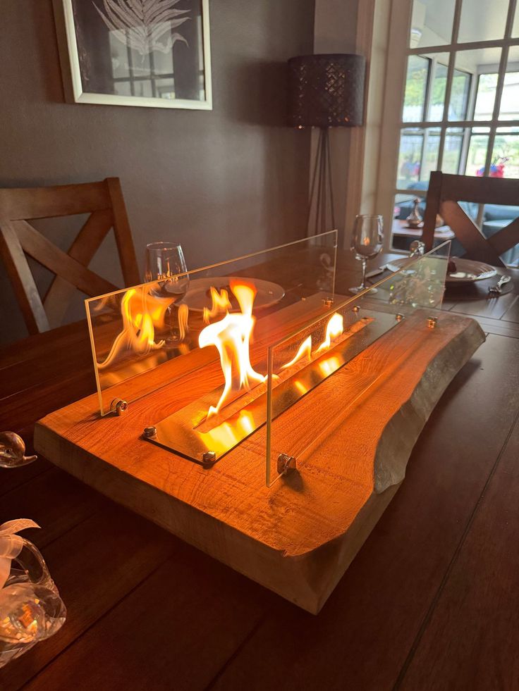 a wooden table topped with lots of lit candles