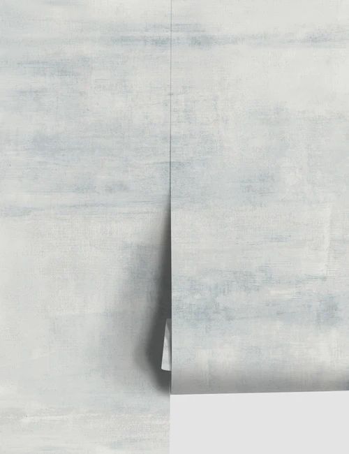 an abstract painting with white and grey colors on the wall, including one corner missing