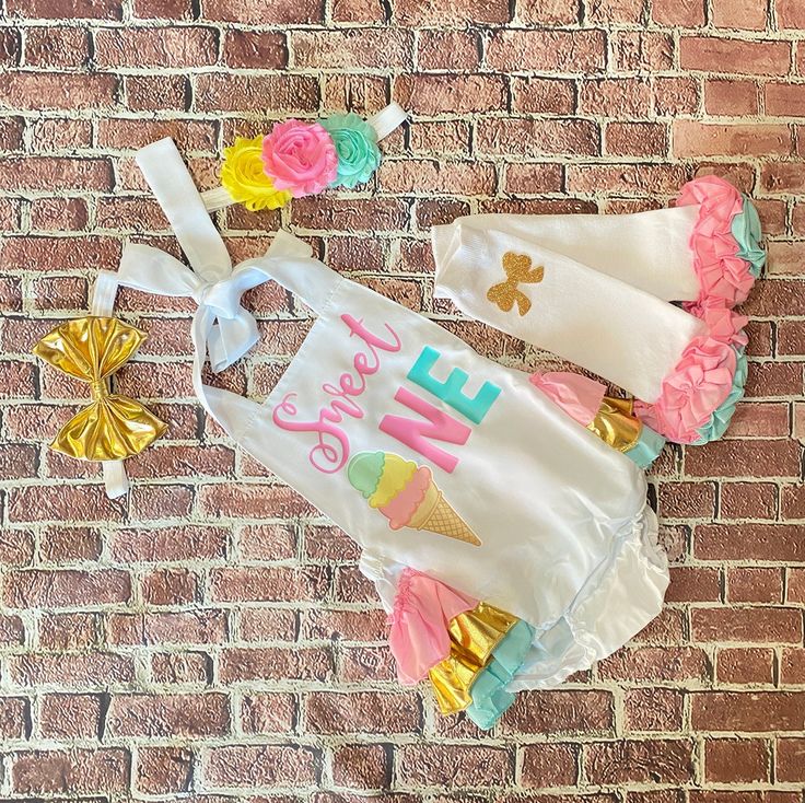 "This adorable romper is perfect for your princess' 1st birthday outfit. It makes a great photo prop for her birthday pictures, birthday invitations or just to remember this special day!! The romper has straps that untie so you can lower or raise the outfit for a better fit. The back of the romper has layers of ruffle and the top of the ruffles is embellished with a gold bow. If you would like a different color bow, please message me with the color that you would like. HEADBANDS- The headband is Fitted Sets For Birthday And Summer, Fitted Sets For Birthday In Summer, Fitted Sets For Summer Birthday, Cute Fitted Bubble Romper For Birthday, Fun White Sets For Birthday, Cute Bubble Romper For Spring Party, Fun White Birthday Sets, Fun White Dresses For Birthday, Cute Spring Party Bubble Romper