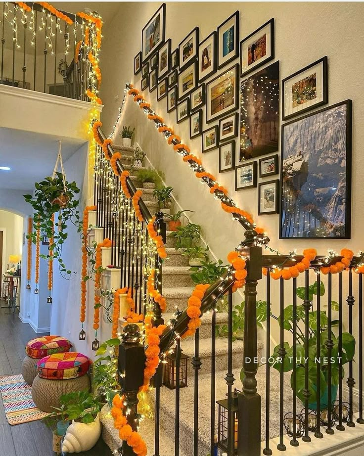 the staircase is decorated with orange garlands and decorations