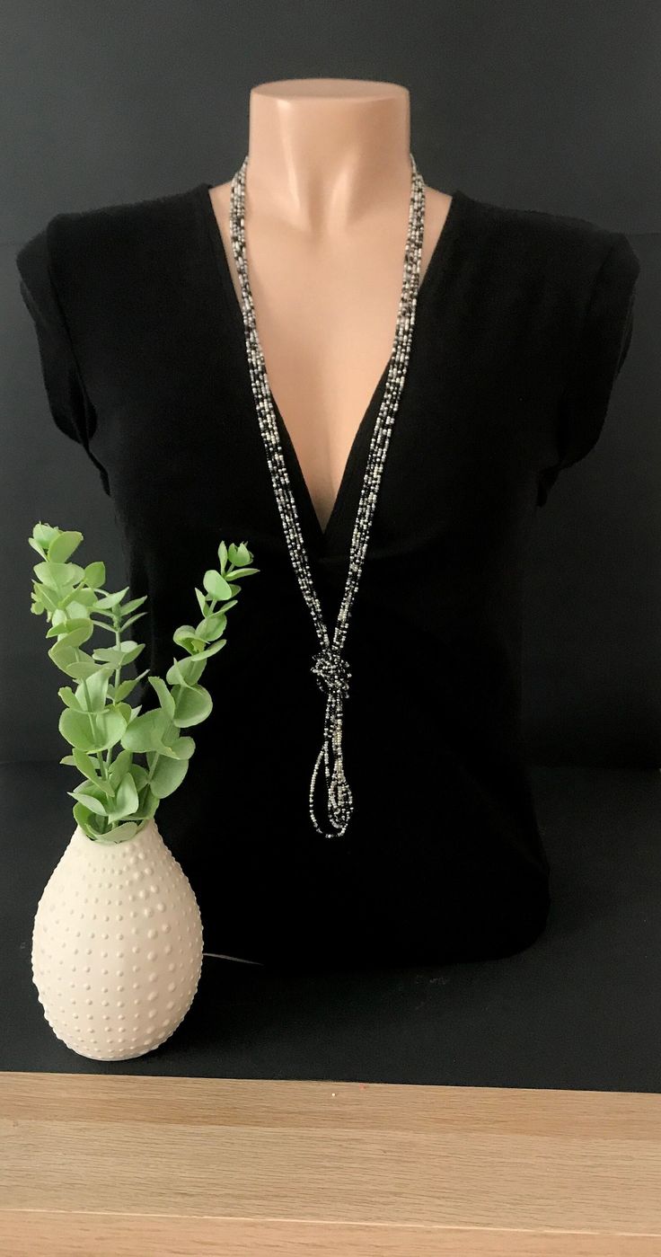 "This is a beaded long necklace that measures about 44 inches long in total in a sparkly silver color. The knot is adjustable, simple to undo and redo at the height you would like! Or you can wear the necklace double up without any knot! It is a very versatile necklace that can be adapted to your taste.   ❤ PROCESSING AND SHIPPING Most orders are made and shipped out in one business day. Please check delivery timeframes for your location on the description below.  ❤ CUSTOM ORDERS If you like thi Elegant Beaded Chain Lariat Crystal Necklace, Elegant Lariat Crystal Necklace With Beaded Chain, Elegant Crystal Lariat Necklace With Beaded Chain, Beaded Silver Layered Necklace For Party, Adjustable Beaded Silver Layered Necklace, Adjustable Silver Beaded Necklace For Party, Bohemian Beaded Layered Necklace For Party, Bohemian Beaded Evening Necklaces, Elegant Beaded Multi-strand Crystal Necklaces