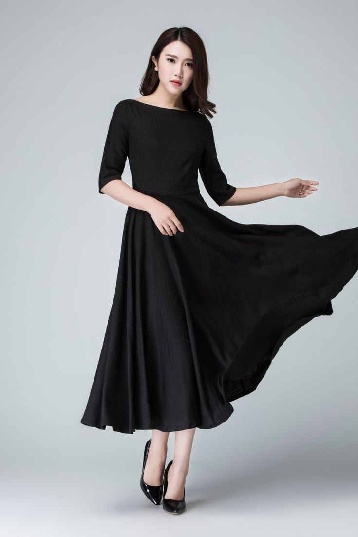 "Create a classic and chic ensemble with this Black maxi dress featuring a fit and flare silhouette . Completed with boat neck linen , three quarter sleeve, it is finished with a hidden Back zipper . This little black dress is perfect for transitioning from the office to an evening in the city . DETAILS * Linen blend * 50% linen , 50% cotton blend * Fitted waist to show off your curves * Boat neckline * Back zipper closure * No pockets * 3/4 sleeve * Midi calf * Wash by hand or machine via cold Linen A-line Evening Dress, Chic Black Boat Neck Midi Dress, Chic Black Midi Dress With Boat Neck, Elegant Fitted Dress With Wide Hem, Elegant Black Fit And Flare Maxi Dress, Evening A-line Linen Dress, Black Fit And Flare Maxi Dress, Black A-line Fit And Flare Maxi Dress, Chic Black Boat Neck Dress