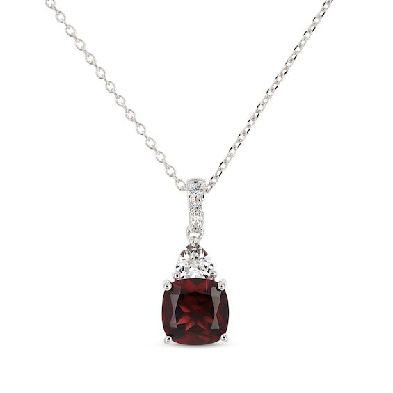 For her January birthday celebration or to mark any special occasion, thhs necklace is a stylish choice. Crafted in sterling silver A rich cushion-cut garnet is topped with a dazzling trillion-cut white lab-created sapphire White lab-created sapphires sparkle along the bail Bezel-set round garnets shimmer on both sides of the setting to complete the look The adjustable 18-inch cable chain secures with a lobster clasp Silver Birthstone Necklace For Formal Occasions, Elegant Garnet Necklaces For Anniversary, Classic Garnet Necklace For Formal Occasions, Classic Sterling Silver Cushion Cut Necklace, Classic Garnet Birthstone Necklace, Elegant Burgundy Jewelry For Anniversary, Classic Burgundy Jewelry For Formal Occasions, Classic Formal Burgundy Jewelry, Classic Garnet Necklace For Anniversary